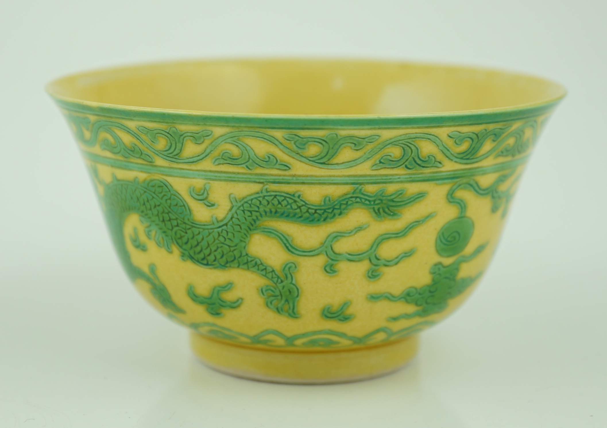 A Chinese green and yellow glazed 'dragon' bowl, Daoguang mark and of the period (1821-50), section of rim broken and restored, hairline cracks